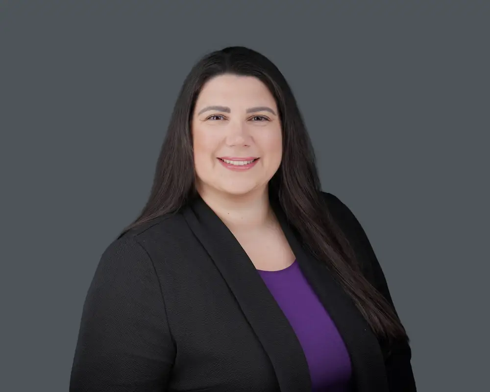 Professional headshot of woman in black blazer