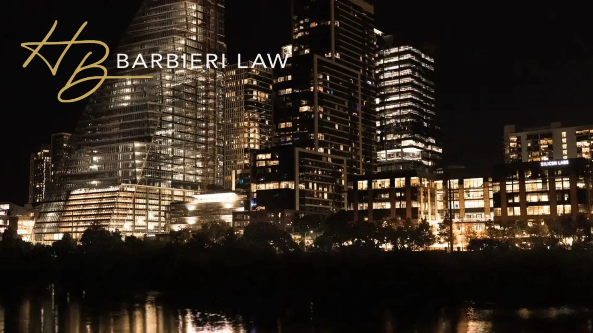 Barbieri Law logo over city skyline at night