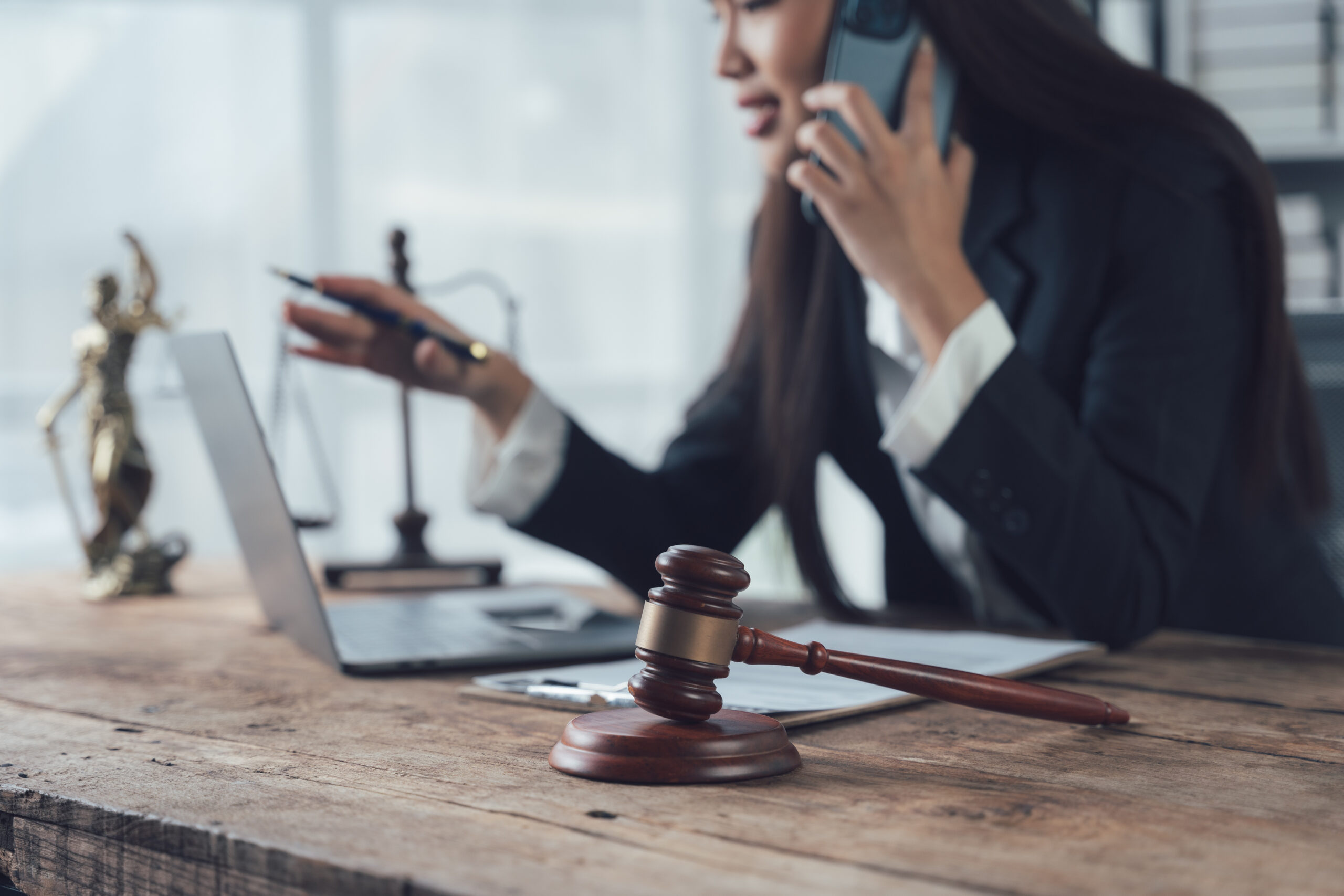 Lawyer on phone at desk with gavel